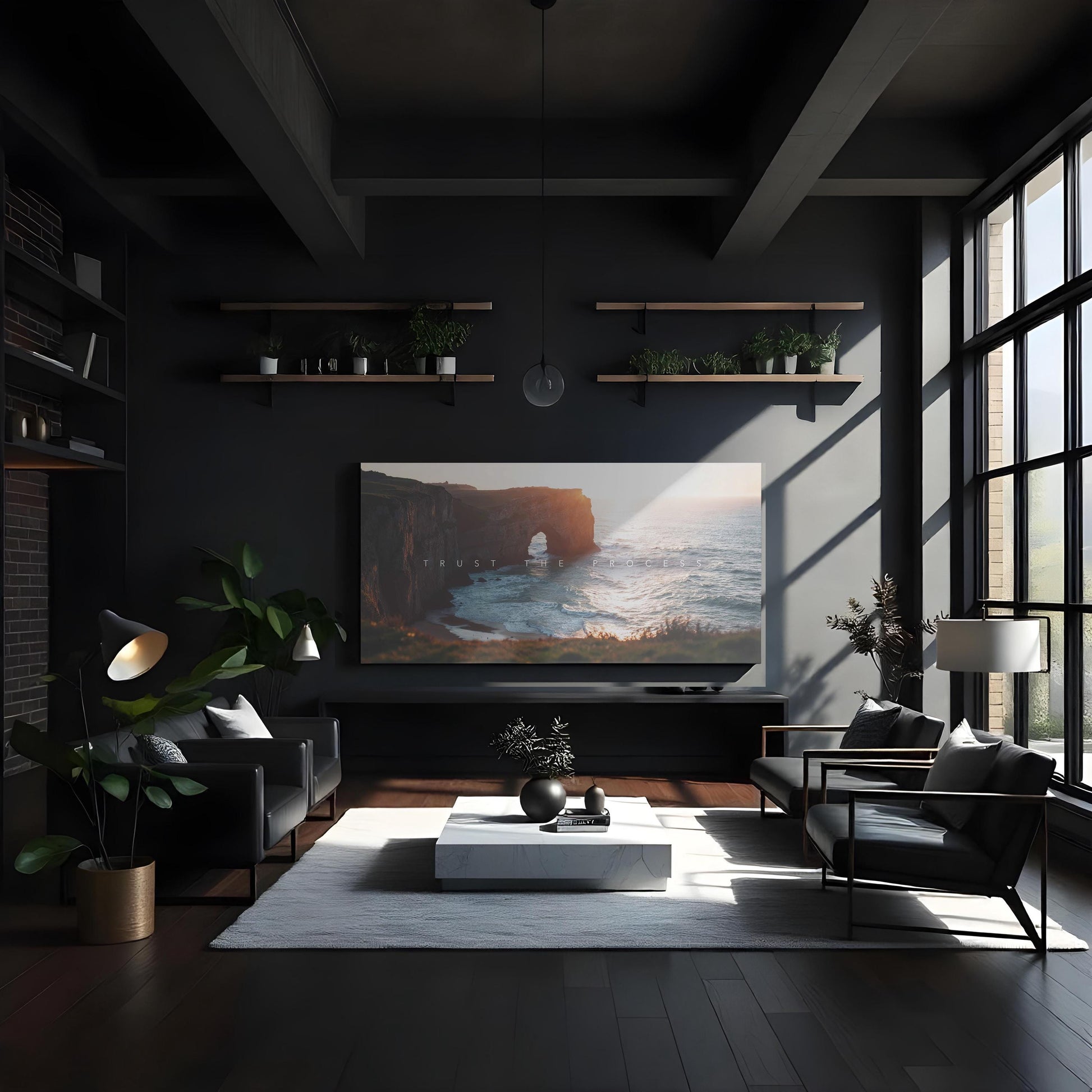 A sophisticated dark-themed living room with high ceilings, floor-to-ceiling windows, and black leather seating. A large canvas print of a coastal cliff and ocean sunset hangs above a sleek black TV stand. Floating wood shelves with potted plants add warmth to the dramatic space. A white marble coffee table and textured rug create contrast, making the artwork a bold, motivational focal point.