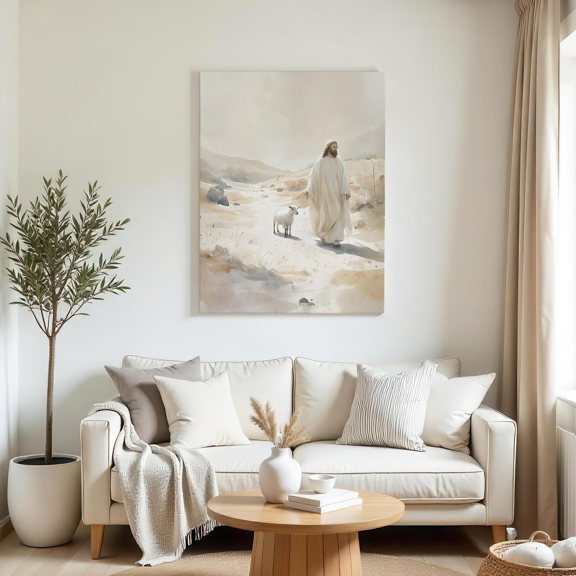 A minimalist living room with a large canvas of Jesus walking with a lamb in a desert landscape. The space features a cream sofa, neutral cushions, a wooden coffee table with vases, a cozy throw, and a potted tree, creating a calm, serene atmosphere.