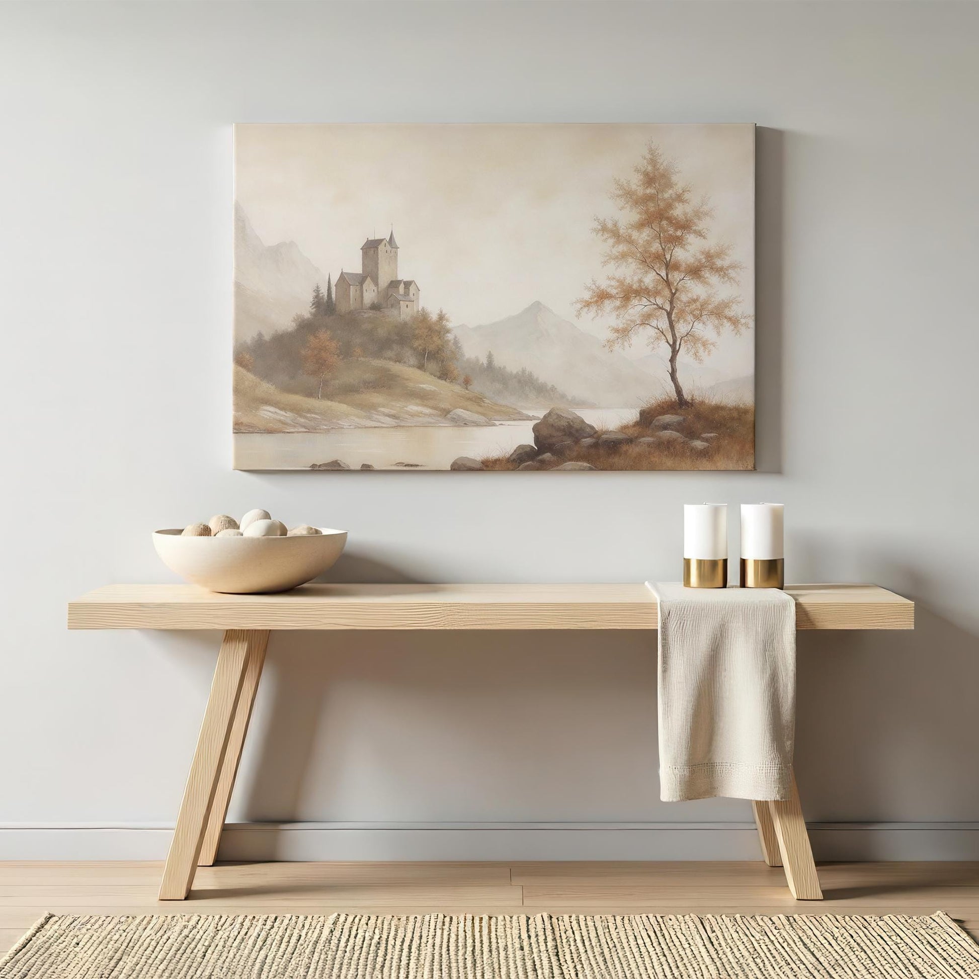 Neutral-toned castle landscape canvas displayed above a wooden console table. Styled with ceramic decor and gold-accented candles for a warm, elegant, and inviting interior setting.