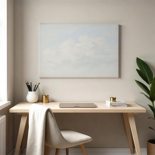 Tranquil cloudscape canvas in a minimalist home office. Styled with a wooden desk, neutral decor, and greenery for a peaceful and inspiring workspace.
