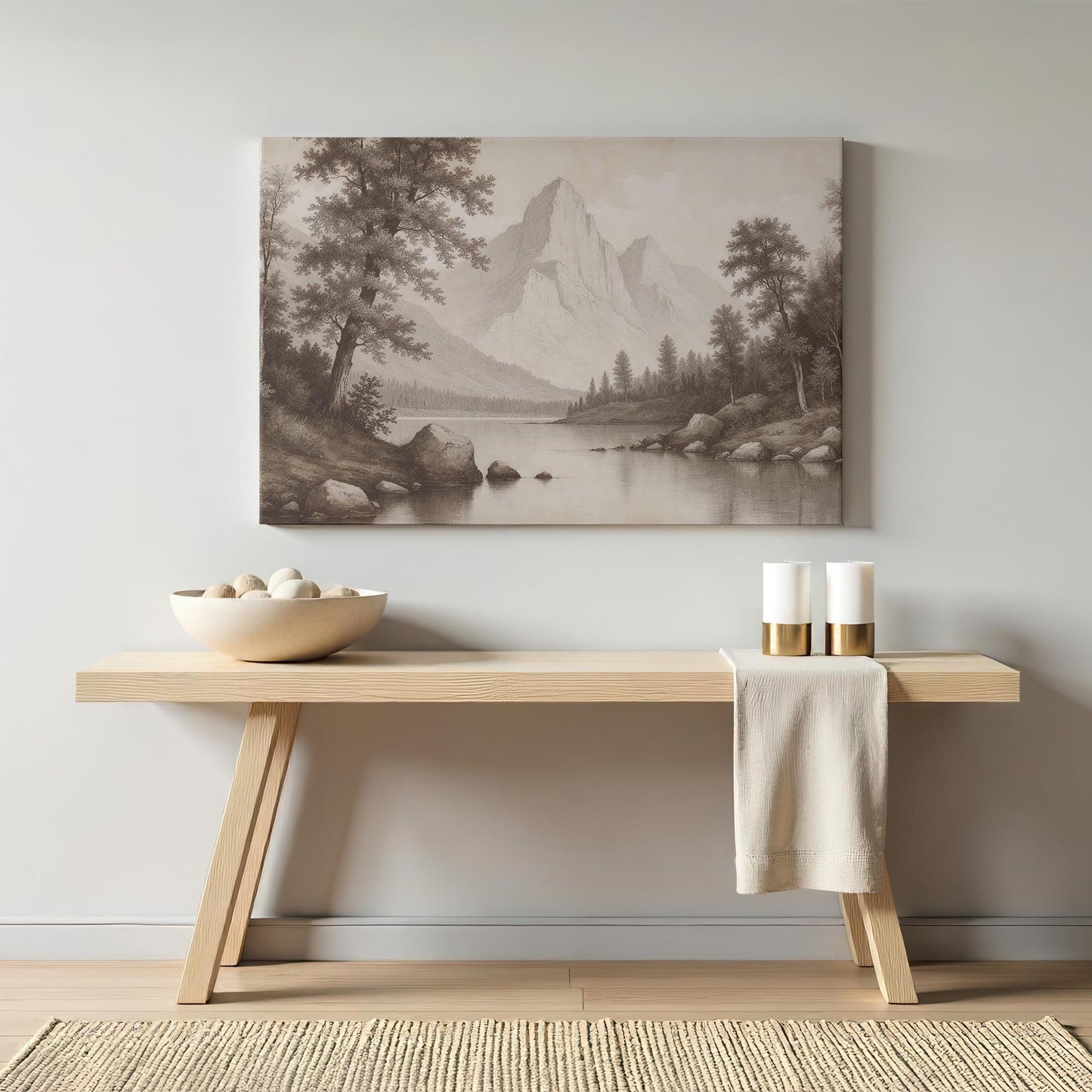 Rustic console table with a sepia mountain landscape canvas above it. The timeless artwork complements a cozy and natural interior aesthetic.