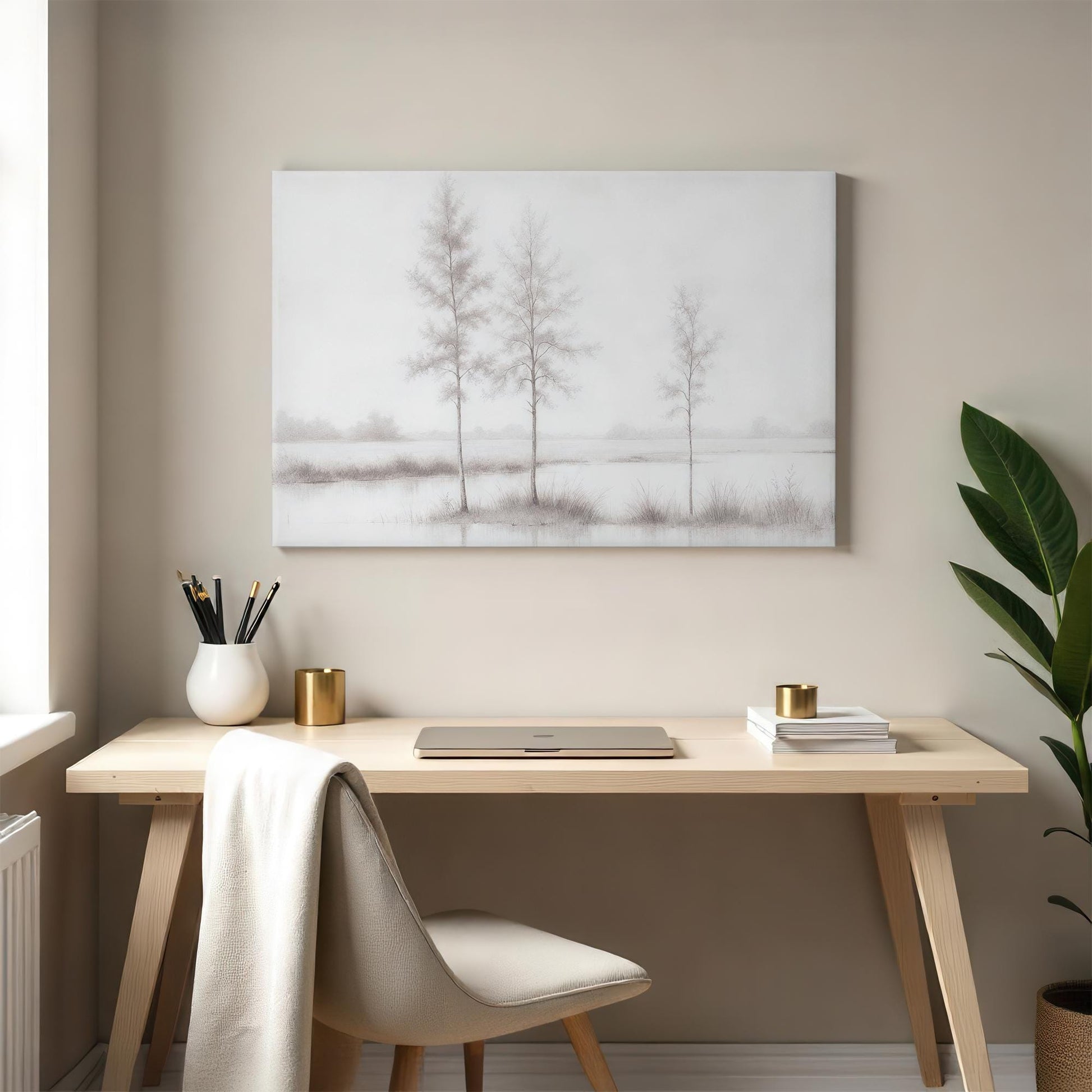 A stylish home office with a neutral palette featuring a large monochrome canvas print of trees over water. The art complements the clean, modern decor, adding a calming, sophisticated atmosphere.
