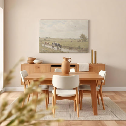 A rustic farmhouse canvas of cows in a lush green field, harmonizing with a wood dining table, ceramic dishware, and soft linen textures. A perfect blend of country charm and modern decor.