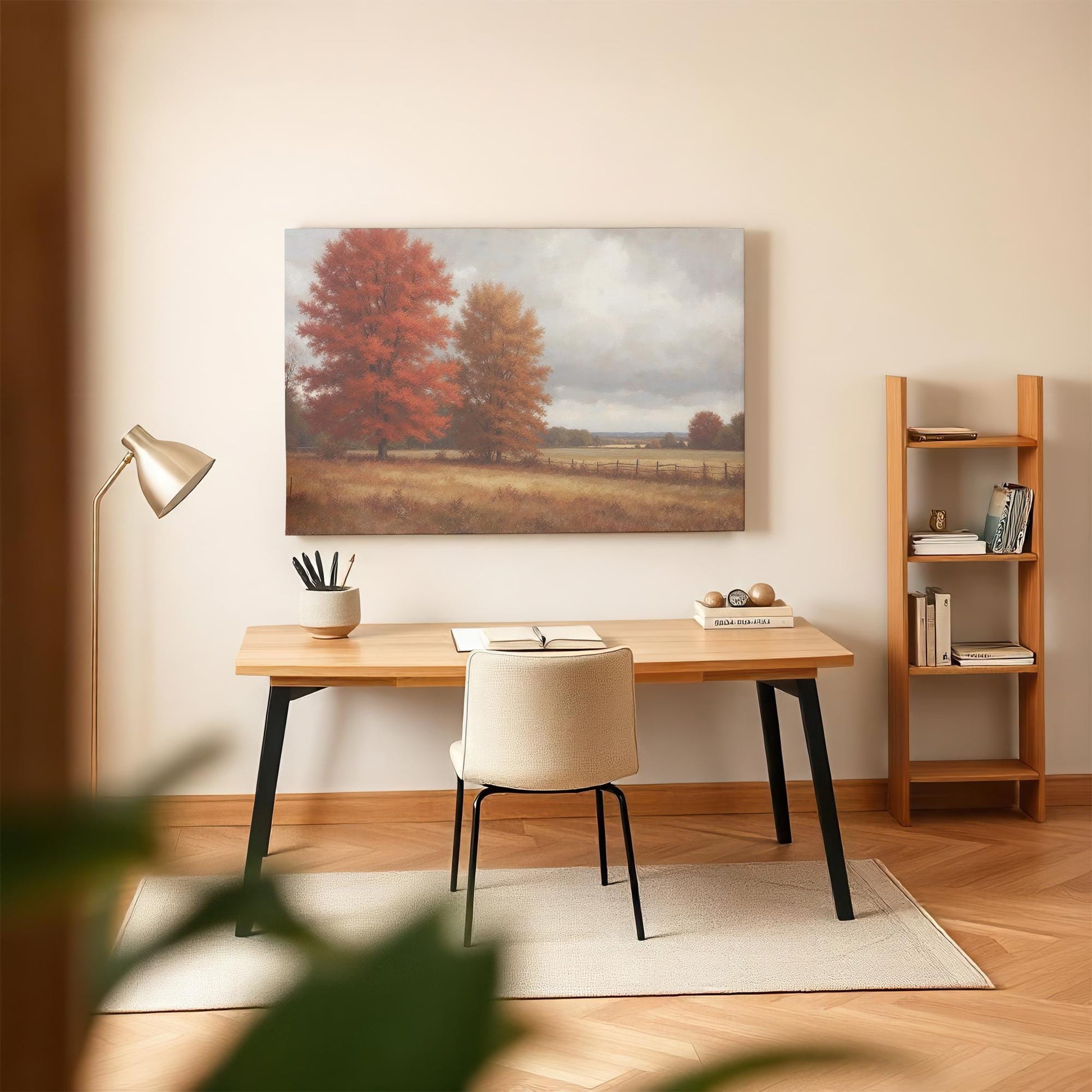 Warm-toned countryside canvas print featuring vibrant autumn trees, styled in a minimalist home office with a modern desk, bookshelf, and cozy workspace aesthetic.