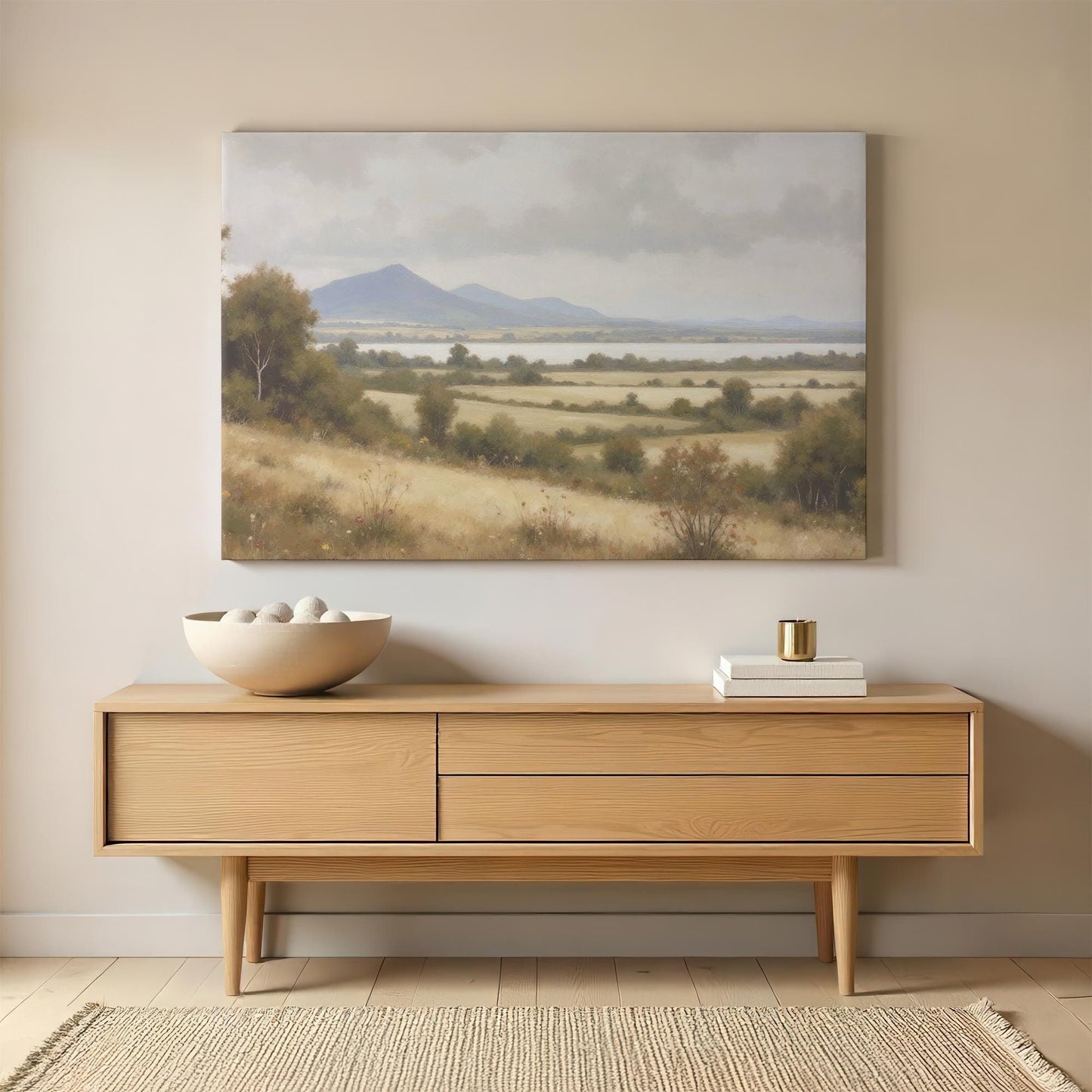 Large canvas print of a scenic countryside landscape with rolling hills, a peaceful lake, and distant mountains. The soft, neutral tones blend seamlessly with modern rustic home decor.