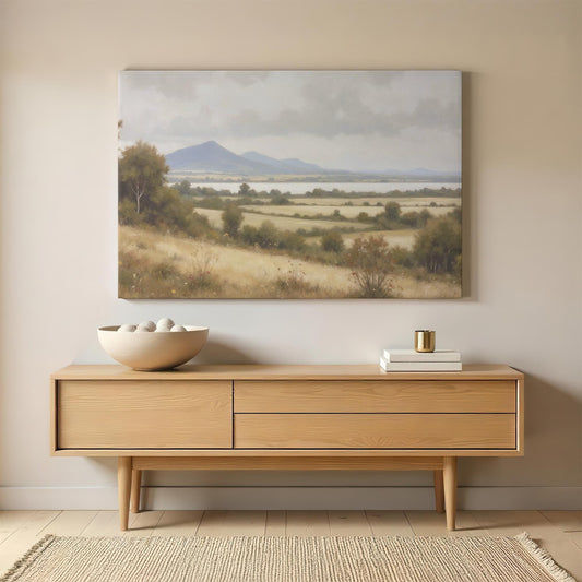 Large canvas print of a scenic countryside landscape with rolling hills, a peaceful lake, and distant mountains. The soft, neutral tones blend seamlessly with modern rustic home decor.