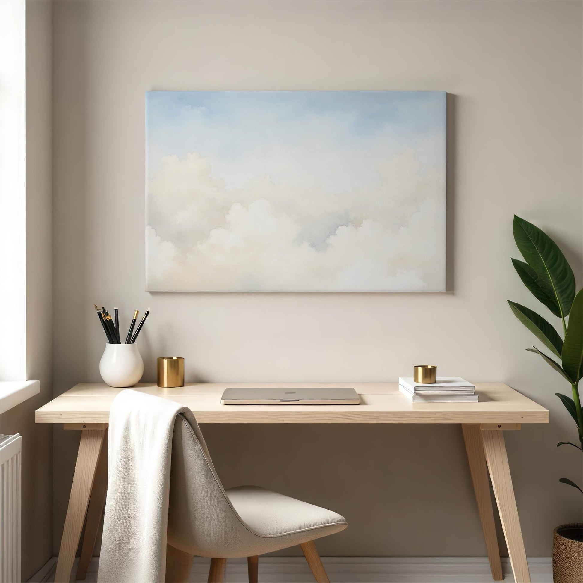 Elegant cloudscape wall art in a modern home office with neutral tones. The minimalist desk setup with a plant and gold accents enhances the serene and calming ambiance of this workspace.