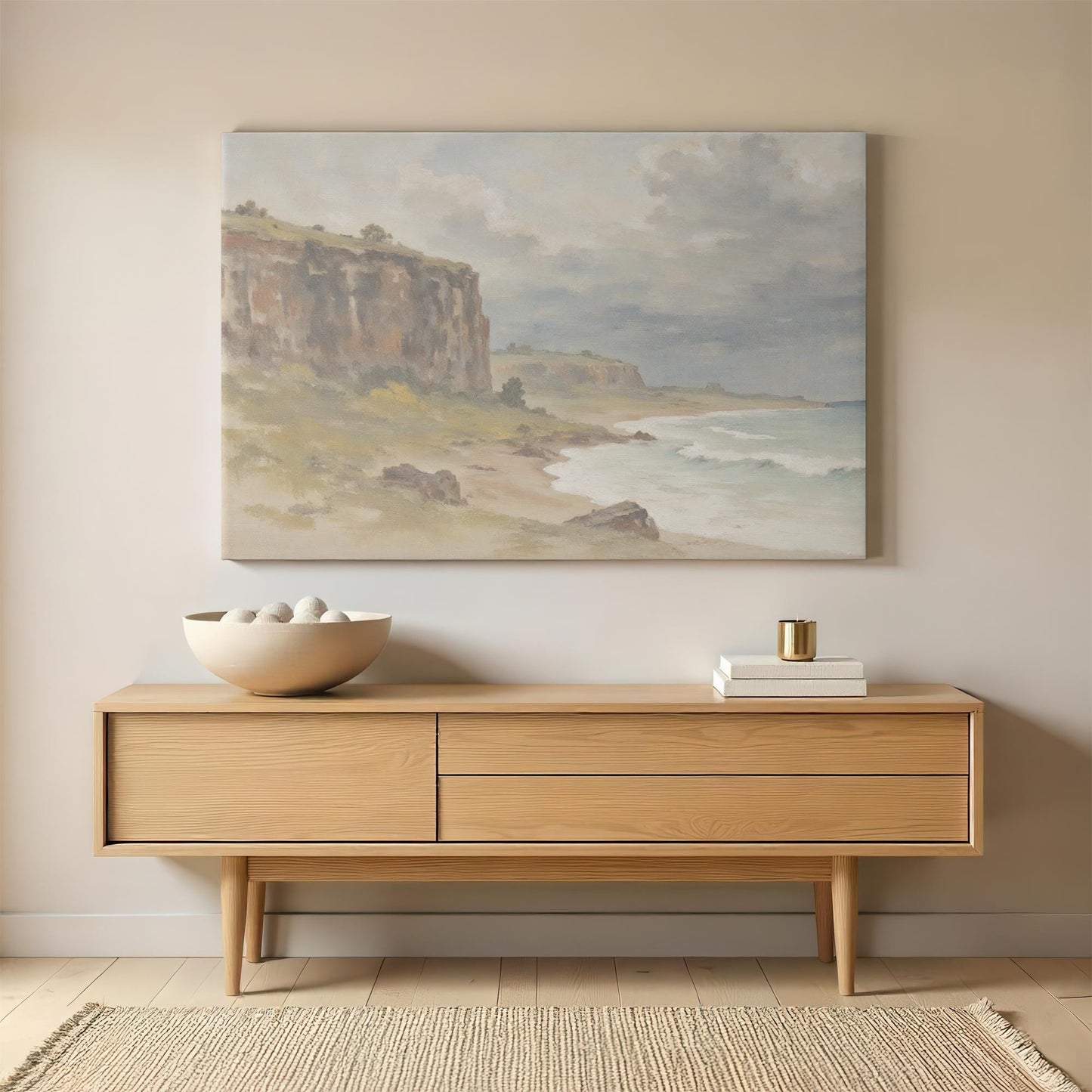 Large coastal landscape canvas print displayed above a wooden sideboard, adding a rustic and tranquil feel to the living room or entryway.