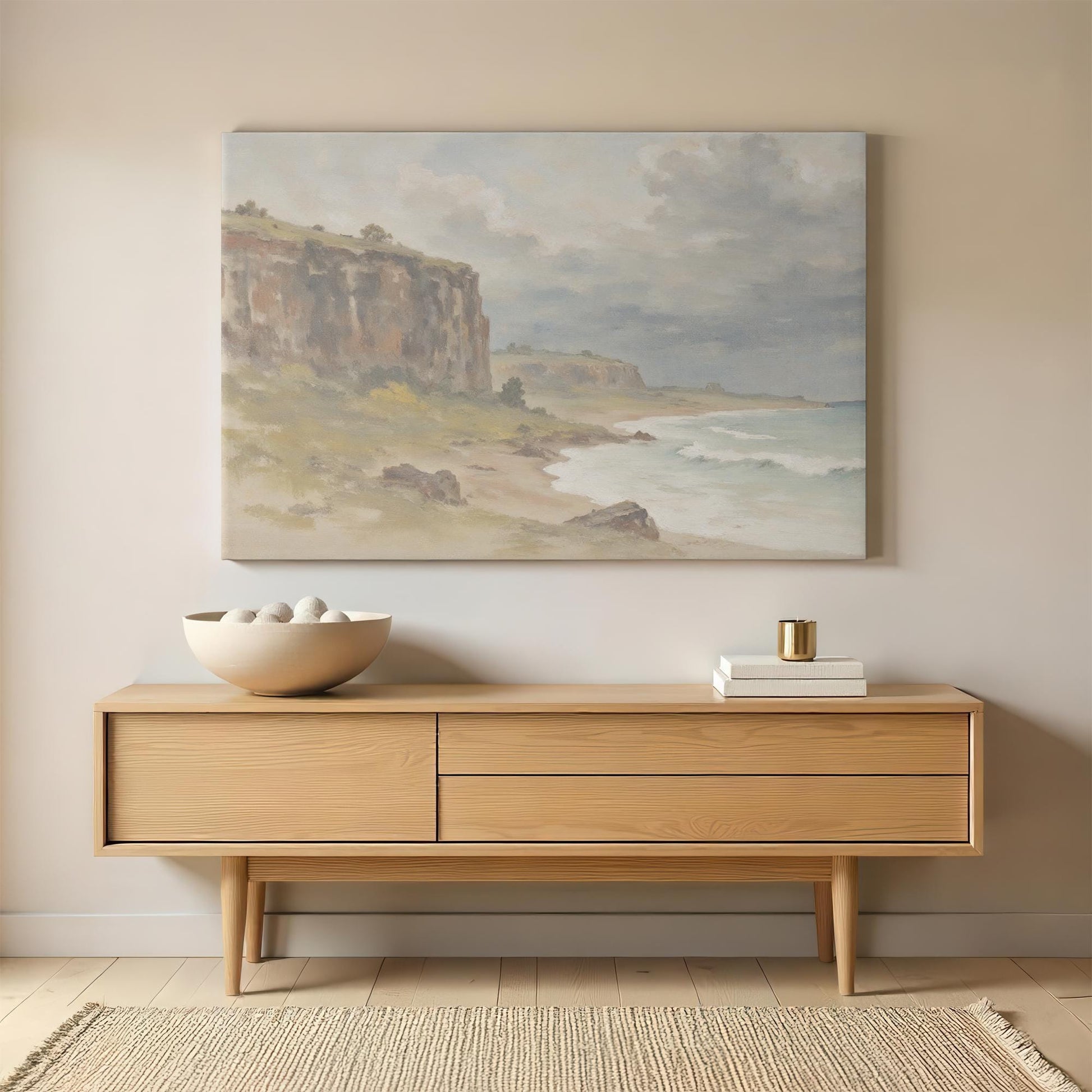Large coastal landscape canvas print displayed above a wooden sideboard, adding a rustic and tranquil feel to the living room or entryway.