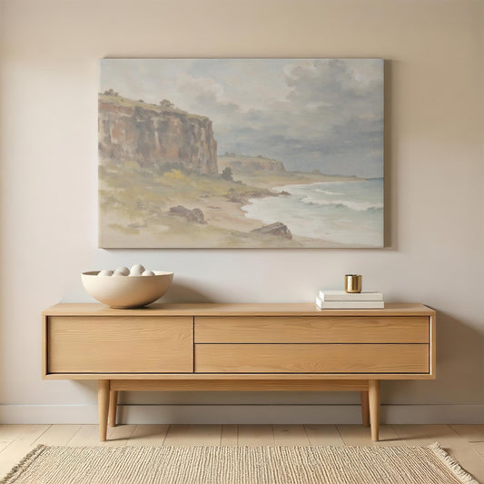 Large coastal landscape canvas print displayed above a wooden sideboard, adding a rustic and tranquil feel to the living room or entryway.