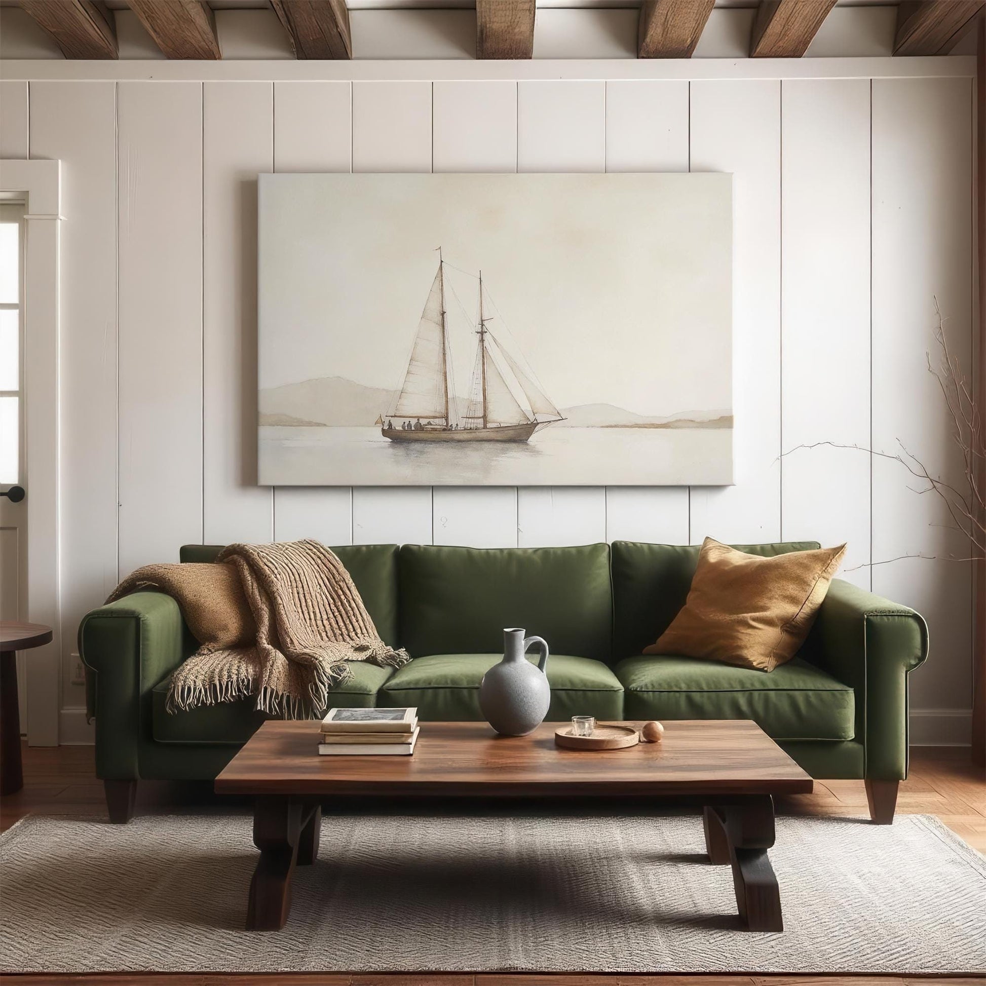 A modern living room featuring a large sailboat canvas print above a green sofa. The cozy setting includes a wooden coffee table, neutral-toned decor, and rustic ceiling beams for a warm, inviting atmosphere.