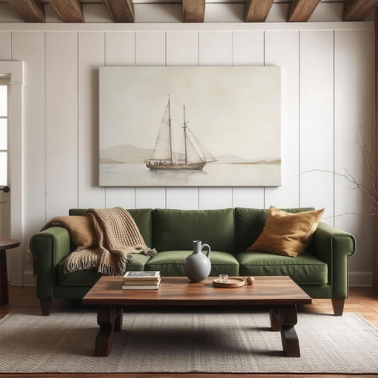 A modern living room featuring a large sailboat canvas print above a green sofa. The cozy setting includes a wooden coffee table, neutral-toned decor, and rustic ceiling beams for a warm, inviting atmosphere.