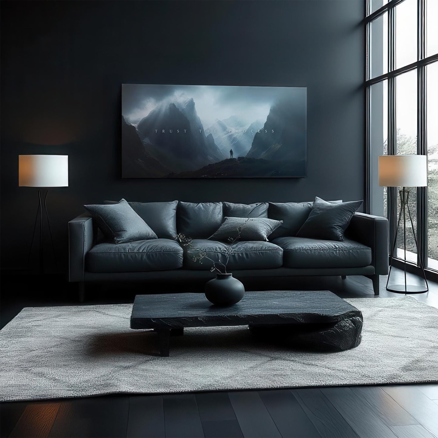 A sophisticated living room with a dark-toned sofa and modern furniture. The &quot;TRUST THE PROCESS&quot; canvas art above the couch serves as a statement piece, complementing the moody, elegant design of the room.
