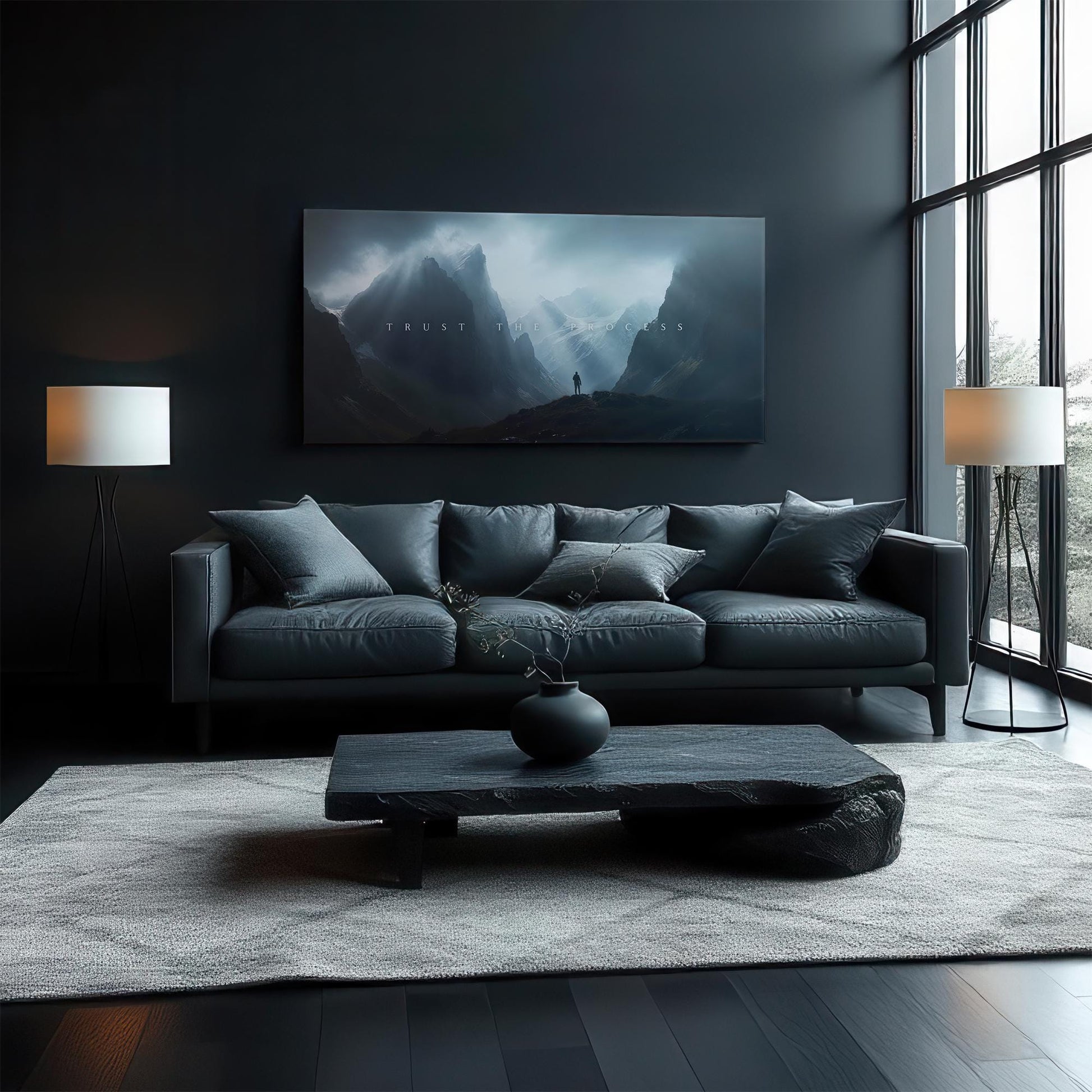 A sophisticated living room with a dark-toned sofa and modern furniture. The &quot;TRUST THE PROCESS&quot; canvas art above the couch serves as a statement piece, complementing the moody, elegant design of the room.