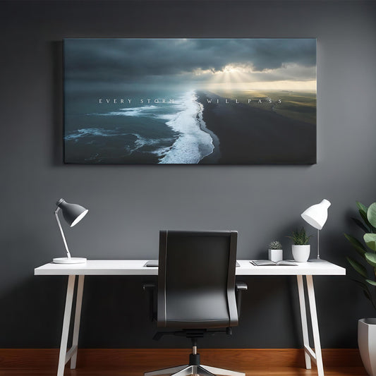 A sleek, modern workspace with a white desk, black chair, and stylish desk lamps. The &quot;Every Storm Will Pass&quot; canvas hangs above, adding an inspiring message to the minimalist and clean design of the room.