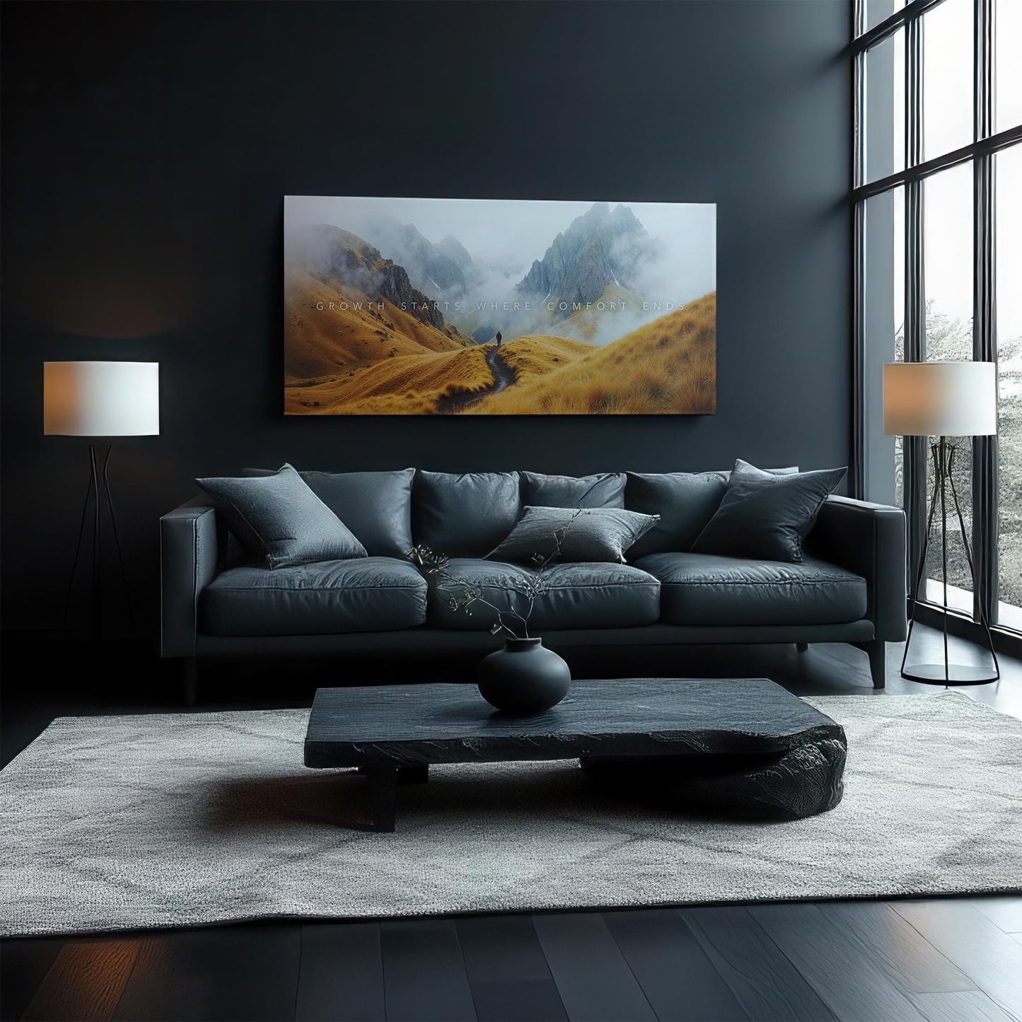 A cozy, contemporary living room featuring a black sofa and dark wooden furniture. The &quot;Growth Starts Where Comfort Ends&quot; canvas is displayed above the couch, adding an inspiring touch to the space. Large windows let natural light brighten the room.
