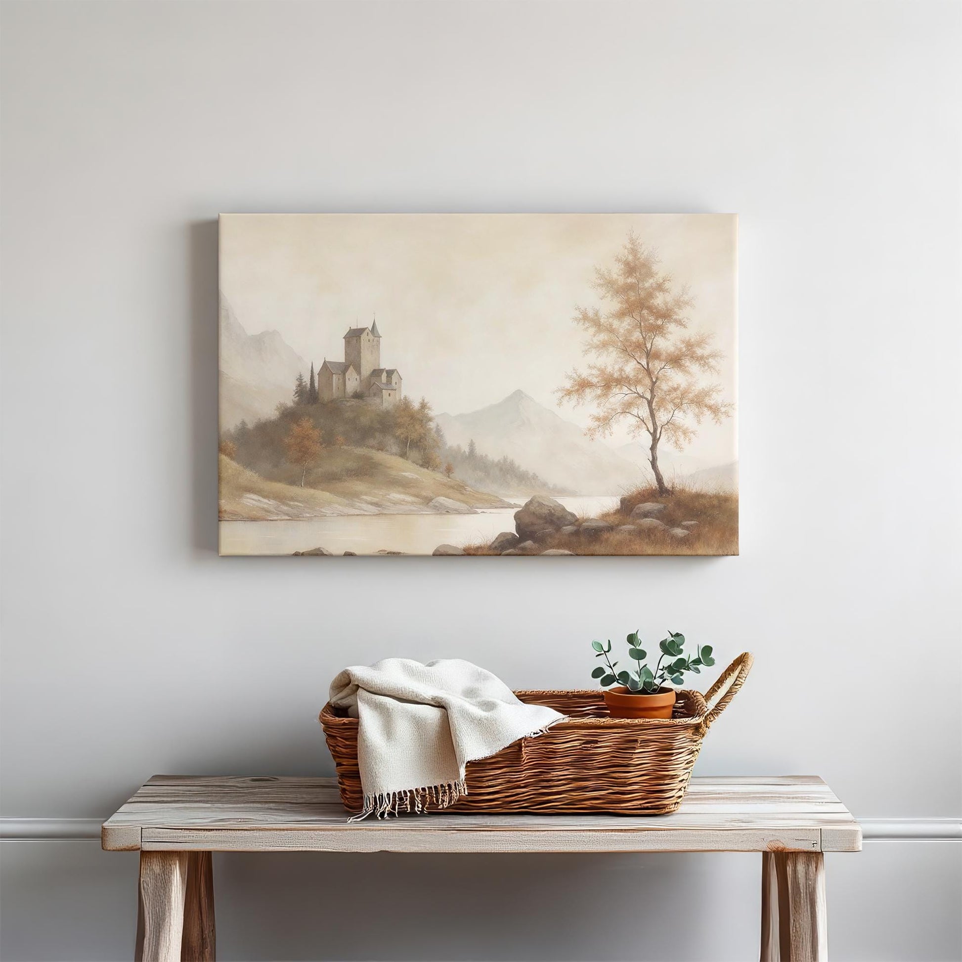 Castle landscape canvas above a rustic wooden bench. Styled with a woven basket, cozy throw blanket, and potted greenery, creating a warm and natural home decor setup.