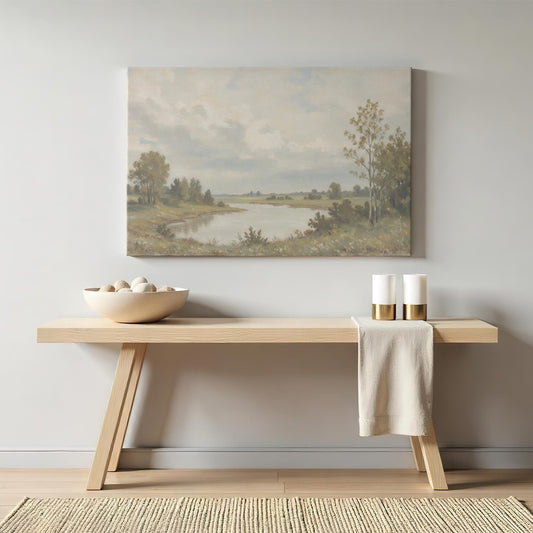 Vintage landscape canvas above a minimalist wooden console. Styled with neutral decor, gold-accented candles, and a soft linen cloth for a warm, tranquil aesthetic.