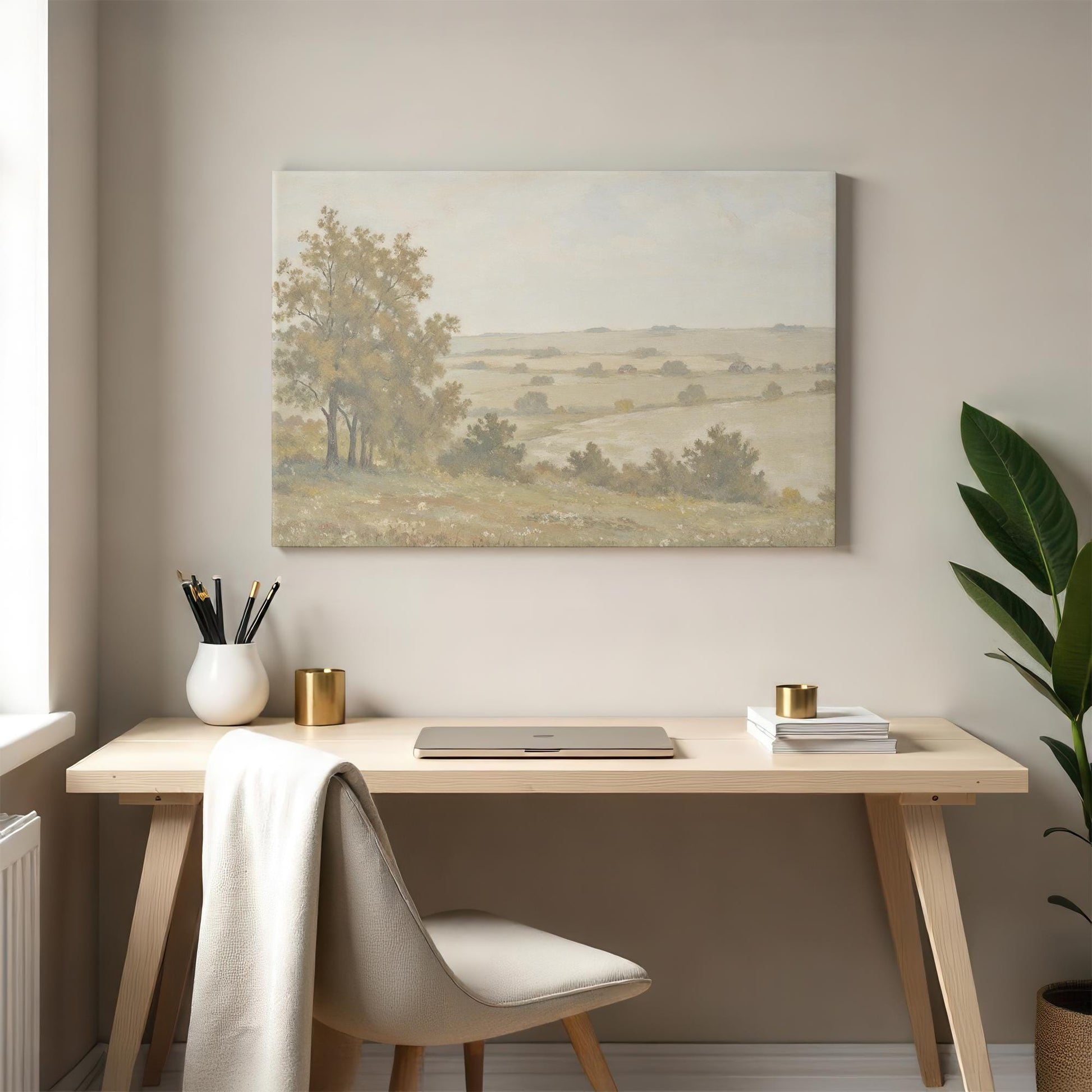 A pastoral landscape canvas displayed in a modern home office. The desk setup includes a sleek laptop, gold-accented decor, and a neutral palette that pairs seamlessly with the gentle tones of the artwork.