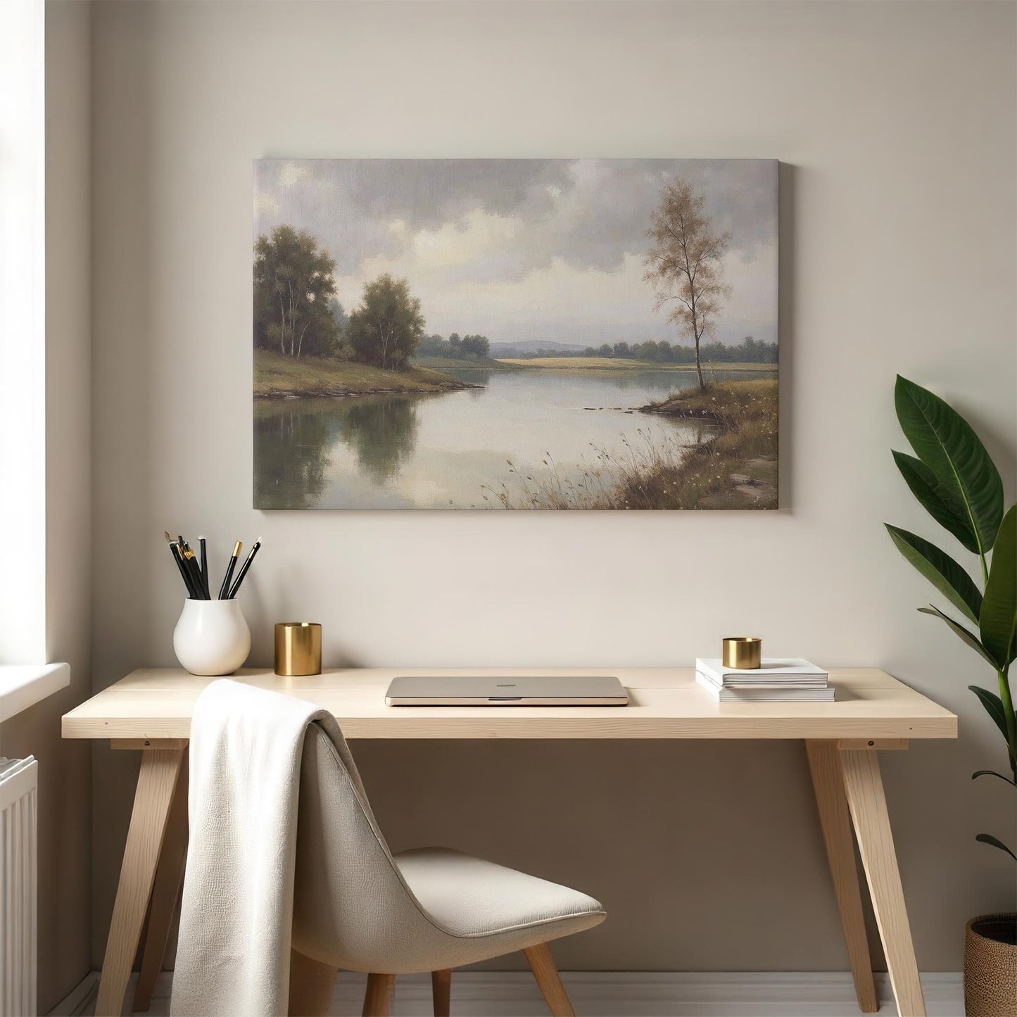 A modern workspace with the landscape canvas print hanging above a wooden desk, accompanied by a neutral-colored chair, books, and decorative gold accents, blending a natural aesthetic with contemporary design.