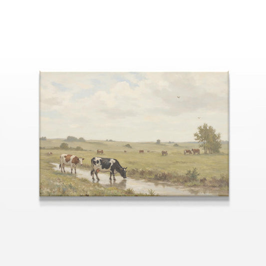 A tranquil rural landscape canvas depicting cows drinking from a stream, elegantly displayed against a white background. Perfect for rustic or farmhouse-style wall decor.