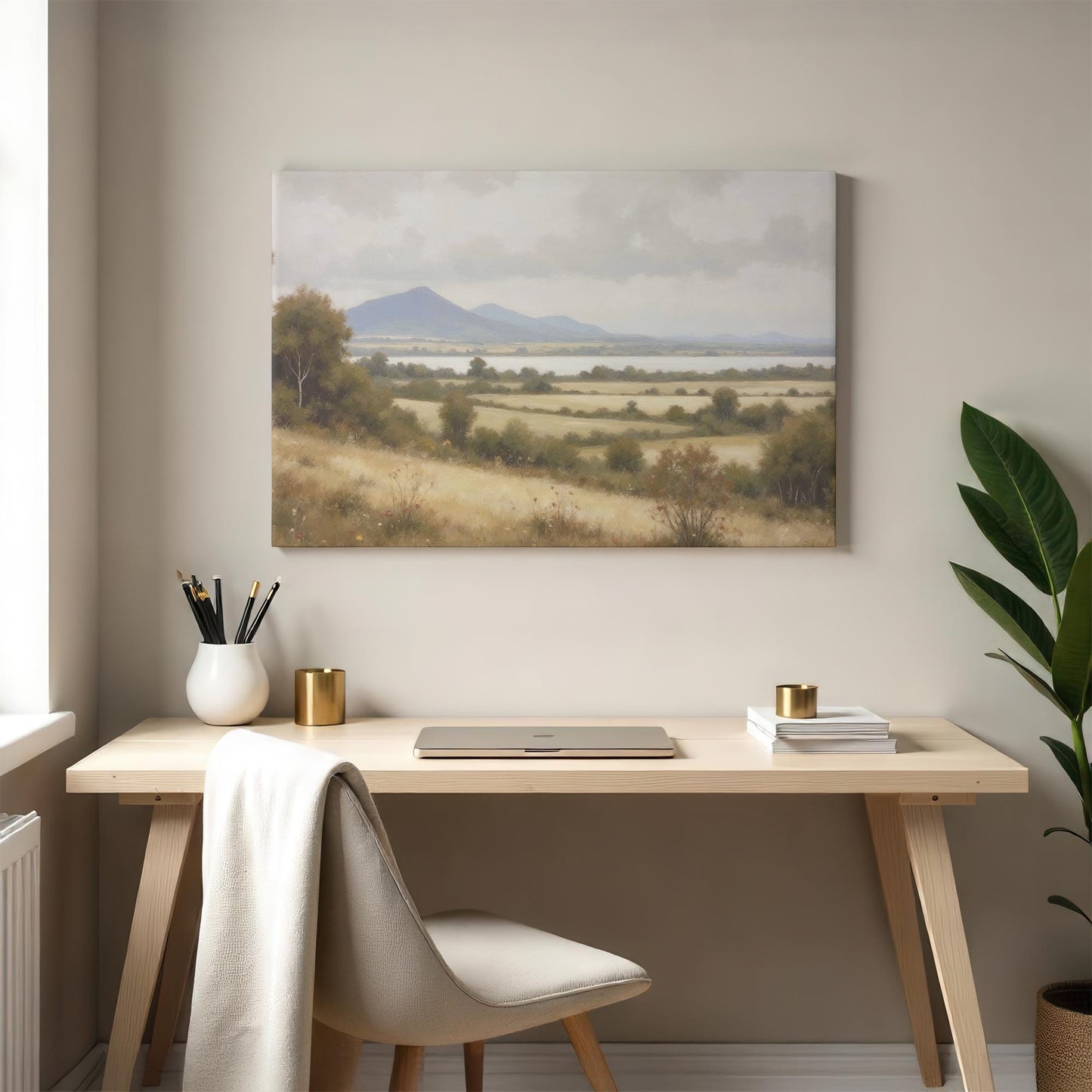 Large rural landscape artwork above a modern home office desk. Earthy tones and rolling hills create a calming ambiance, ideal for workspaces and reading nooks.