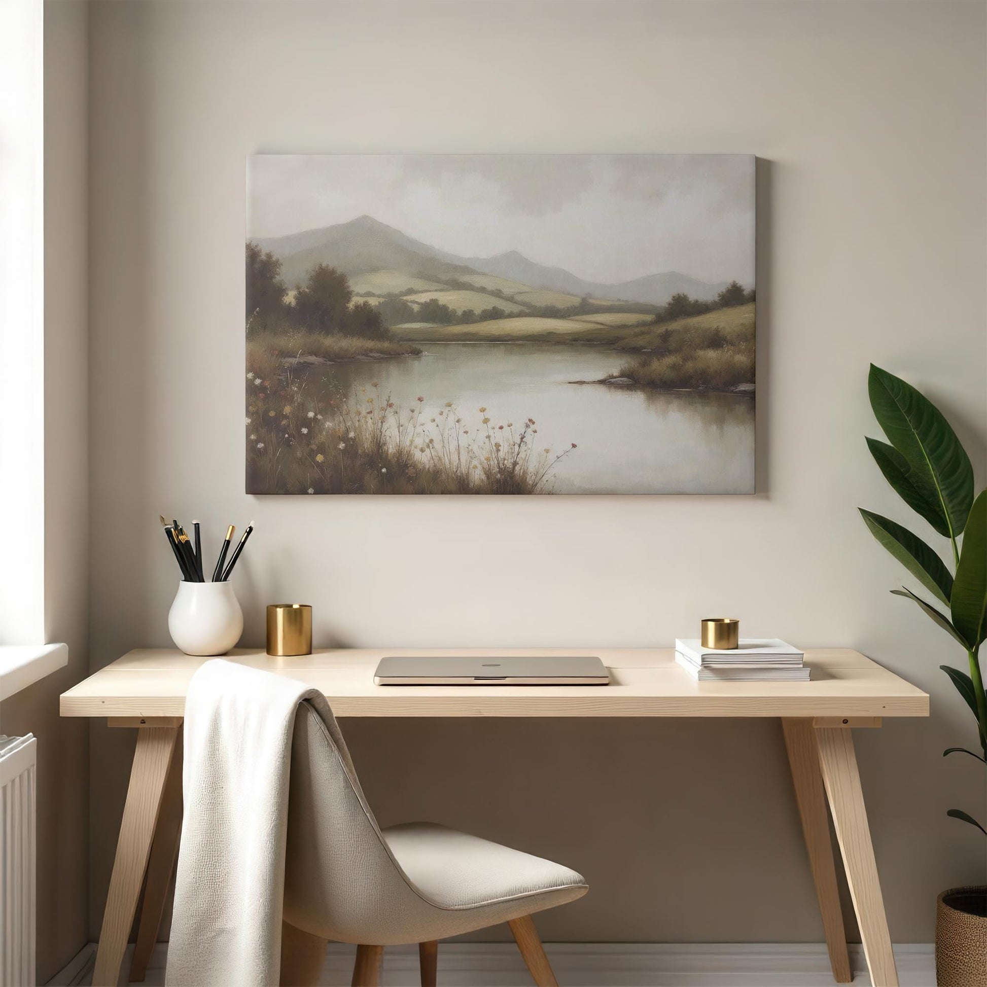 Elegant landscape wall art featuring a tranquil river scene with rolling green hills, enhancing a modern workspace. Styled with a minimalist desk, cozy decor, and warm neutrals, creating an inspiring and peaceful home office atmosphere.
