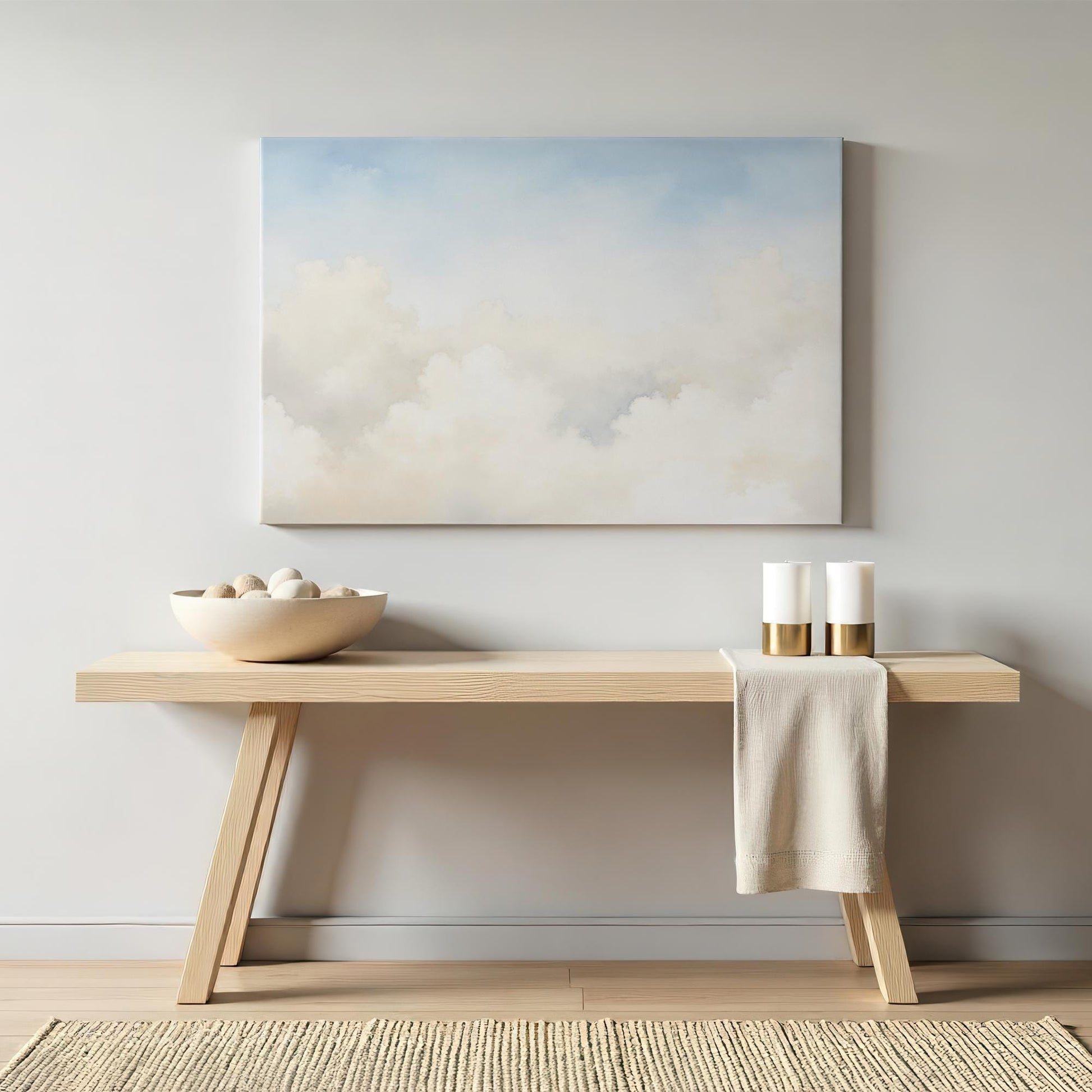Large cloudscape canvas wall art styled above a modern wooden console. Neutral decor elements like ceramic vases and soft textiles create a sophisticated and relaxing interior design aesthetic.