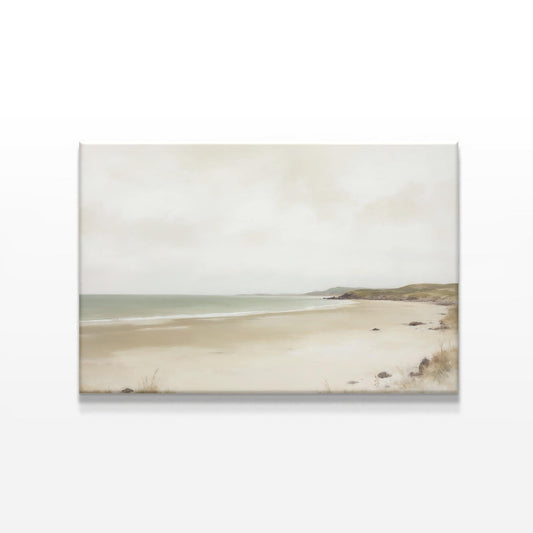 Large-scale beach landscape canvas print with soft beige sand and a tranquil shoreline. The framed artwork is displayed on a white wall, capturing a peaceful, coastal-inspired atmosphere for modern home decor.