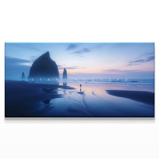Canvas artwork featuring a person walking along a beach at twilight, with towering rock formations in the background and soft colors in the sky, evoking a sense of focus and tranquility.