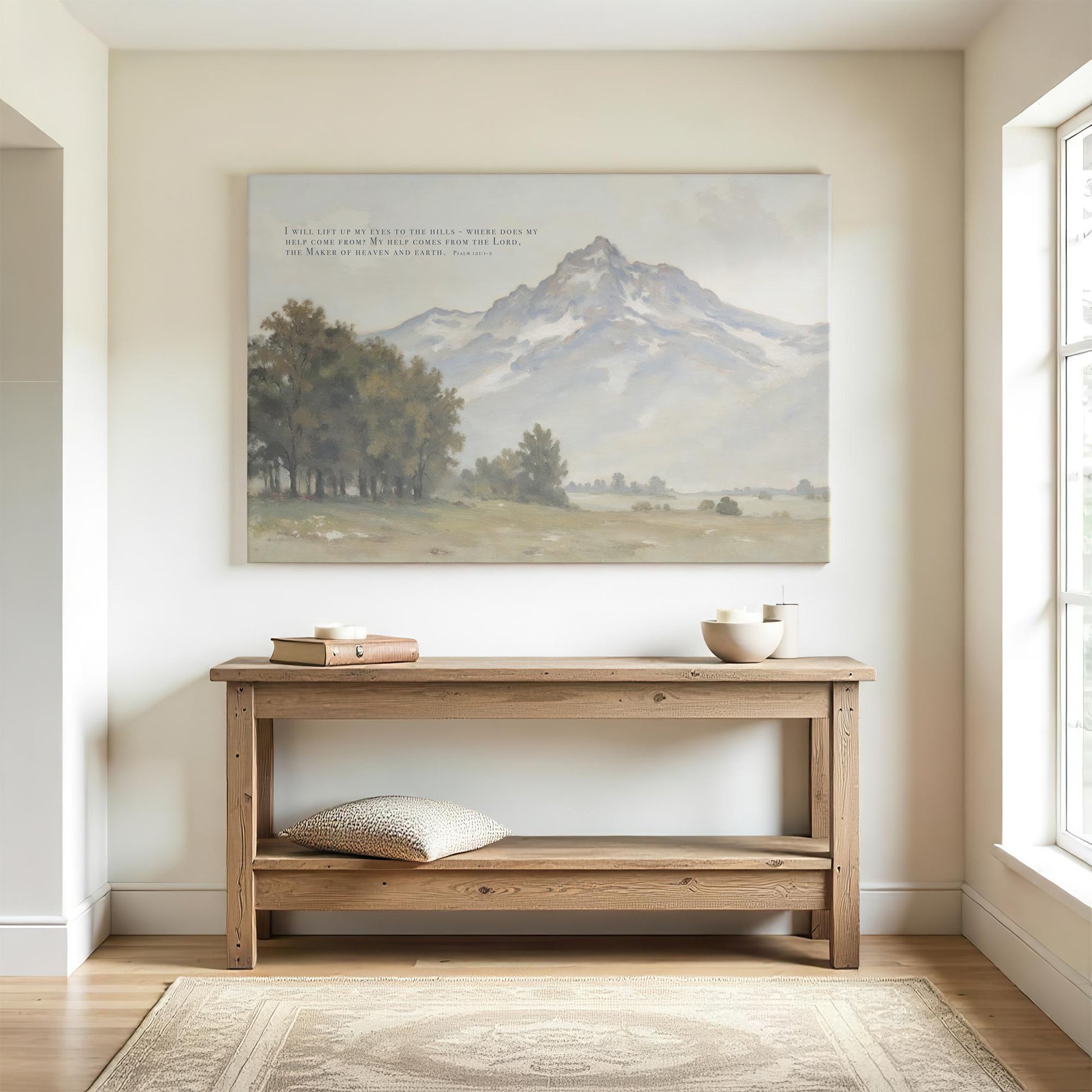 Bright hallway with a wooden console table and simple decor. A large canvas print of Psalm 121:1-2 with a soft mountain landscape is displayed above the table, bringing a calming and spiritual touch to the space.