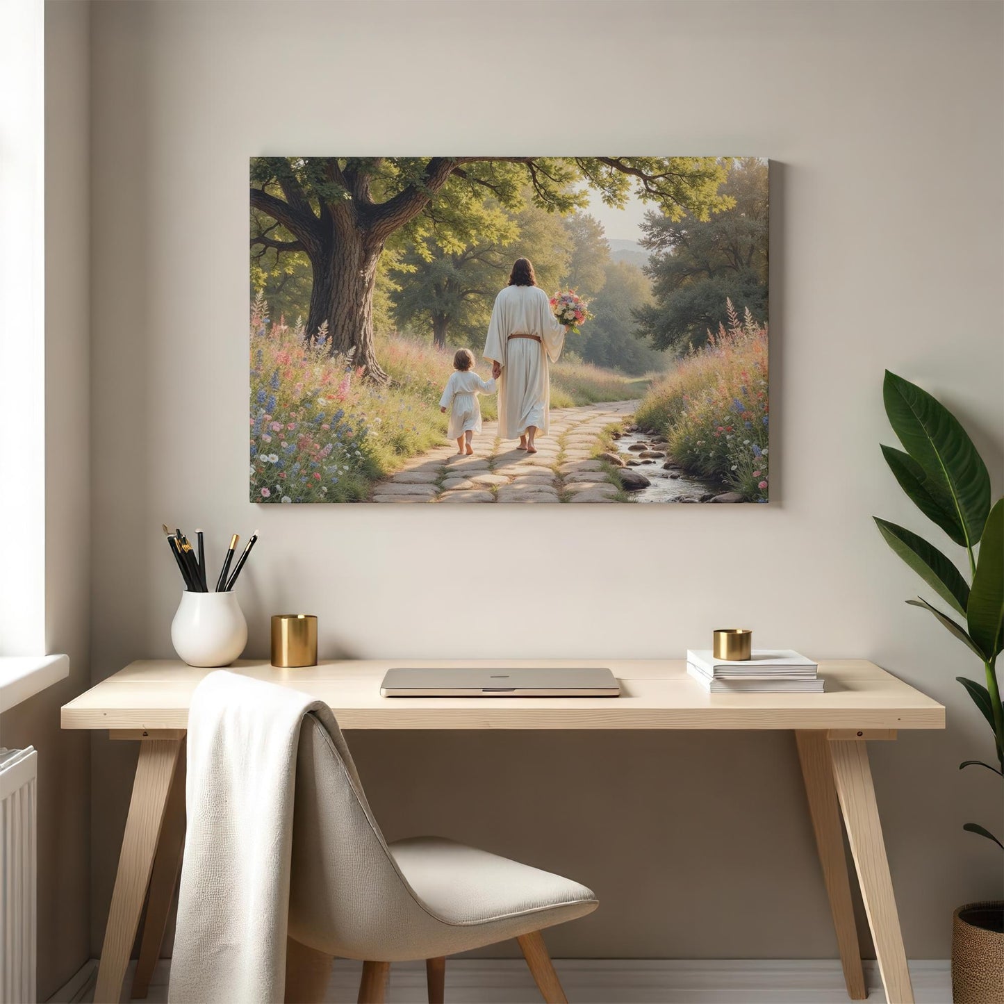 A modern home office with a clean desk and light decor. The &quot;Jesus walking with child&quot; canvas art is prominently displayed, adding a tranquil, inspirational element to the workspace. Sunlight streams through the window, enhancing the serene scene.