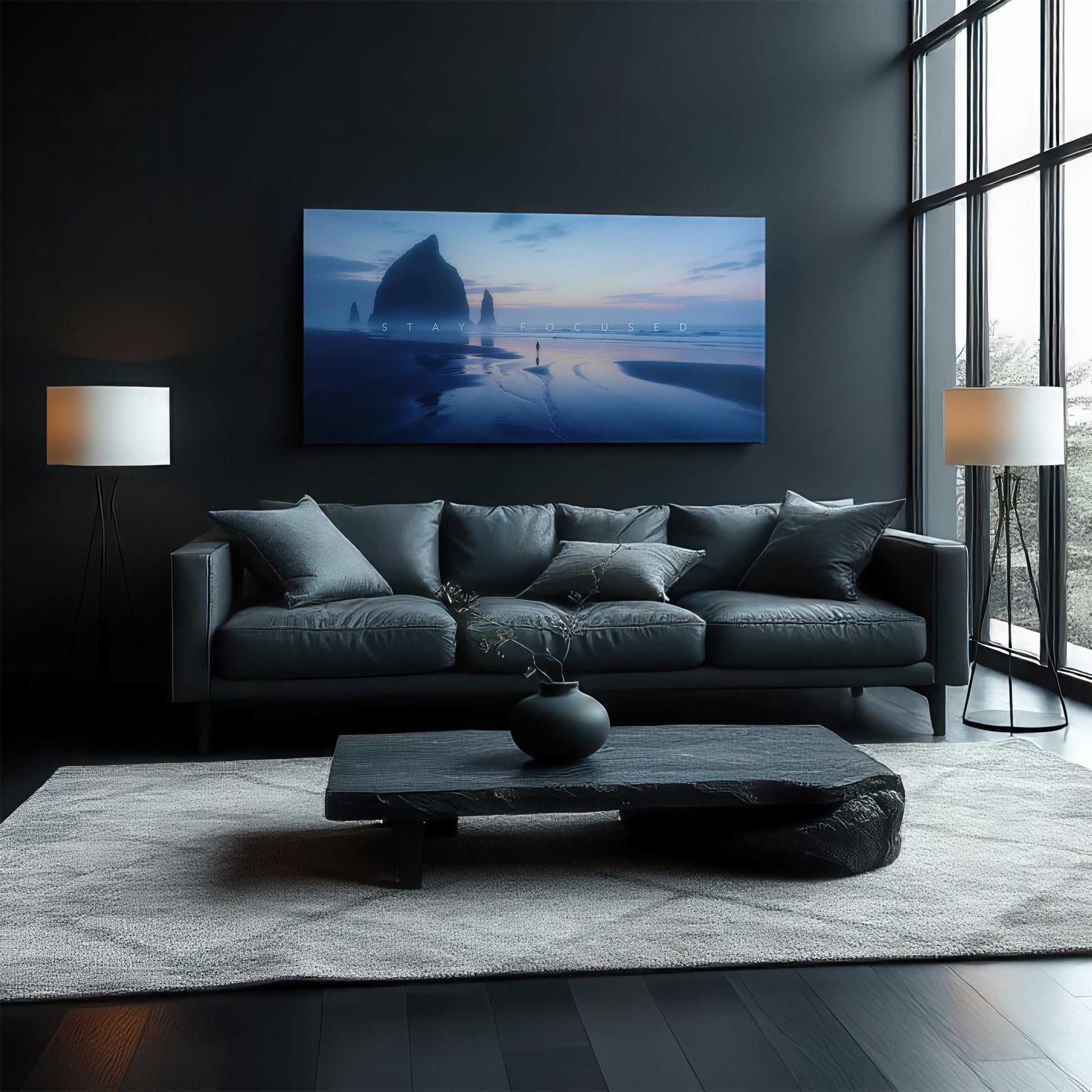 Stylish living room with dark tones and a sleek black couch, featuring a large canvas art of a beach at twilight, evoking a sense of calm and focus in a modern, elegant setting.