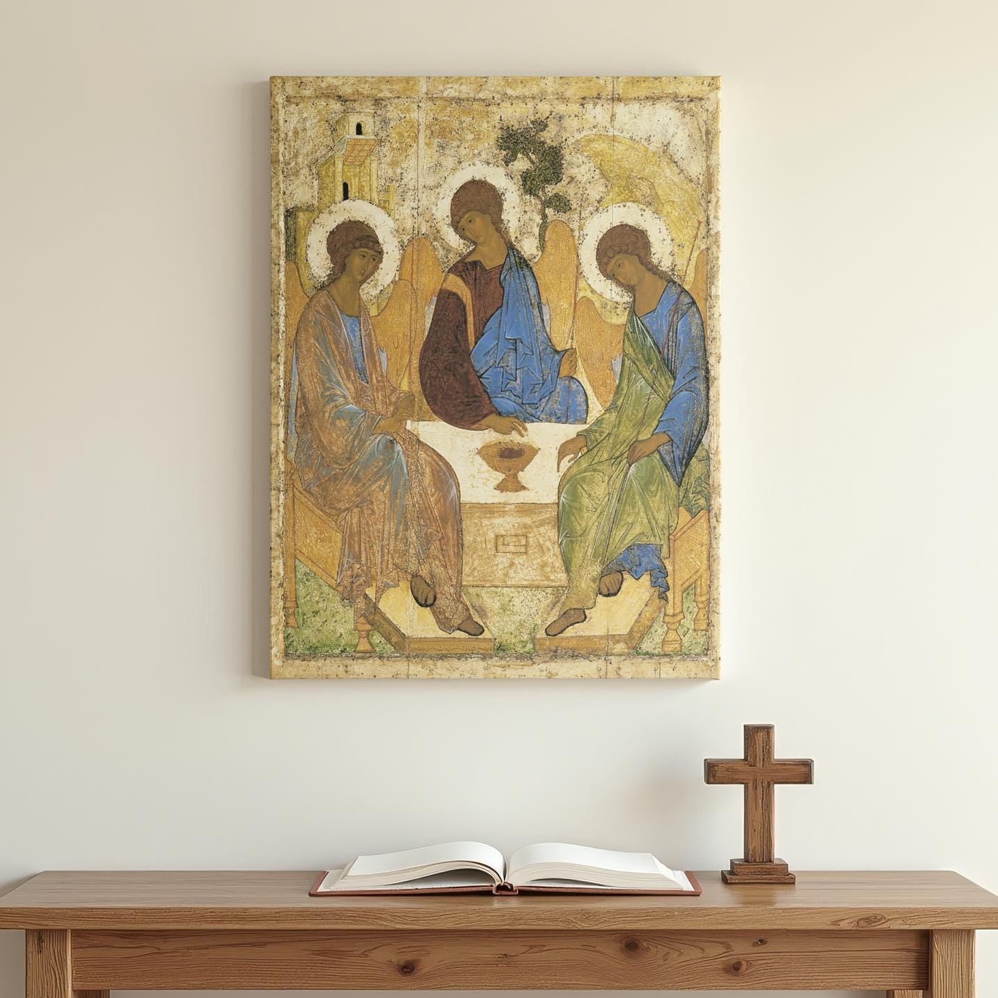 A beautifully framed Orthodox icon of the Holy Trinity by Andrei Rublev hangs on a minimalist white wall. Below, a wooden altar with an open Bible and a cross creates a serene prayer corner.