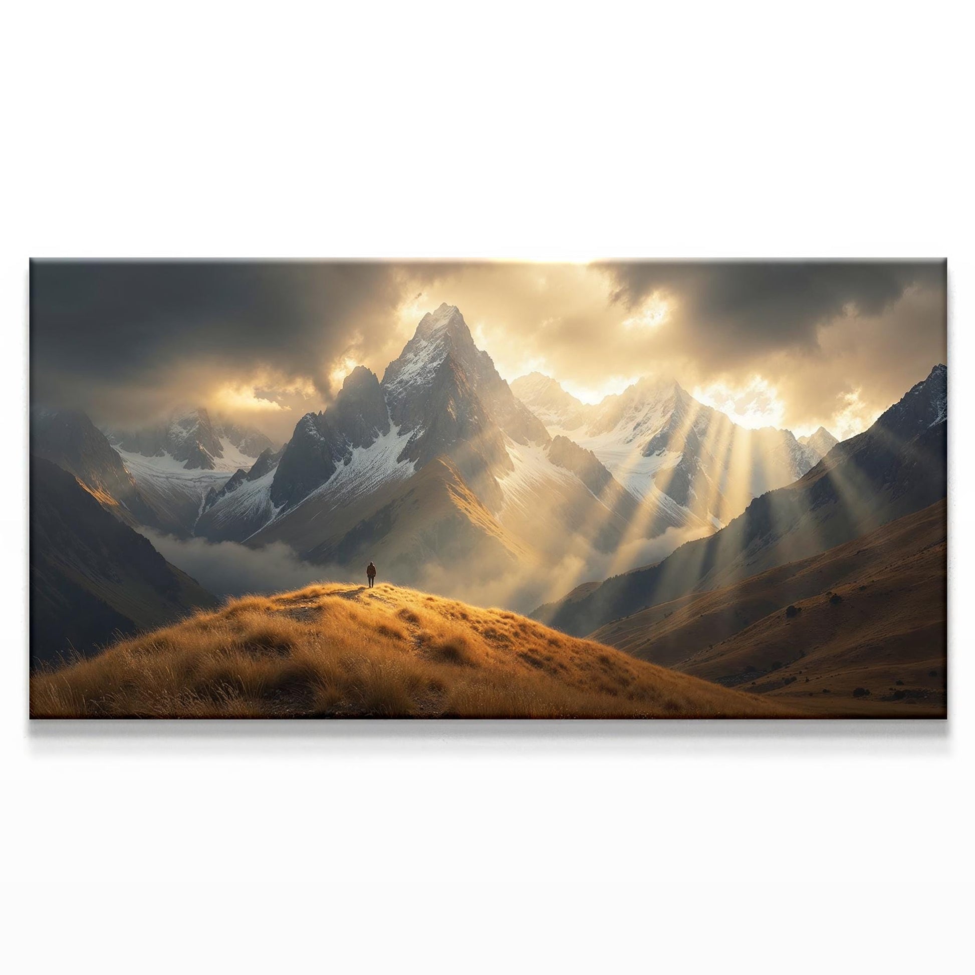 Canvas print of dramatic mountains with a lone figure standing on a golden grassy hilltop, illuminated by sunlight breaking through dark clouds in an atmospheric landscape.