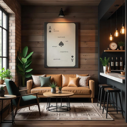 A warm industrial-style lounge featuring a leather sofa, wood-paneled walls, and a large Ace of Spades motivational canvas. A modern bar area with pendant lights and dark metal accents adds contrast. Green plants bring life to the cozy, sophisticated space, making the artwork a statement piece for a stylish, high-end environment.