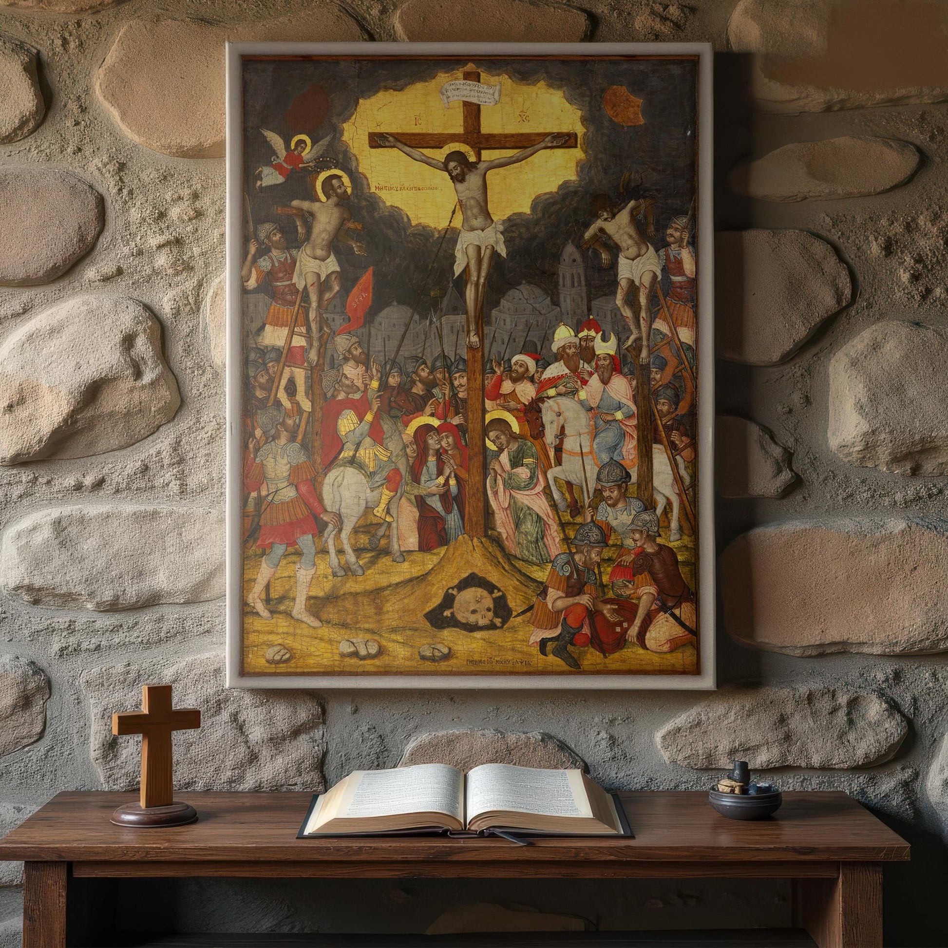 Byzantine Crucifixion icon depicting Christ on the cross between two thieves, surrounded by mourning saints and soldiers, displayed above rustic prayer table with open Bible and wooden cross against stone wall.