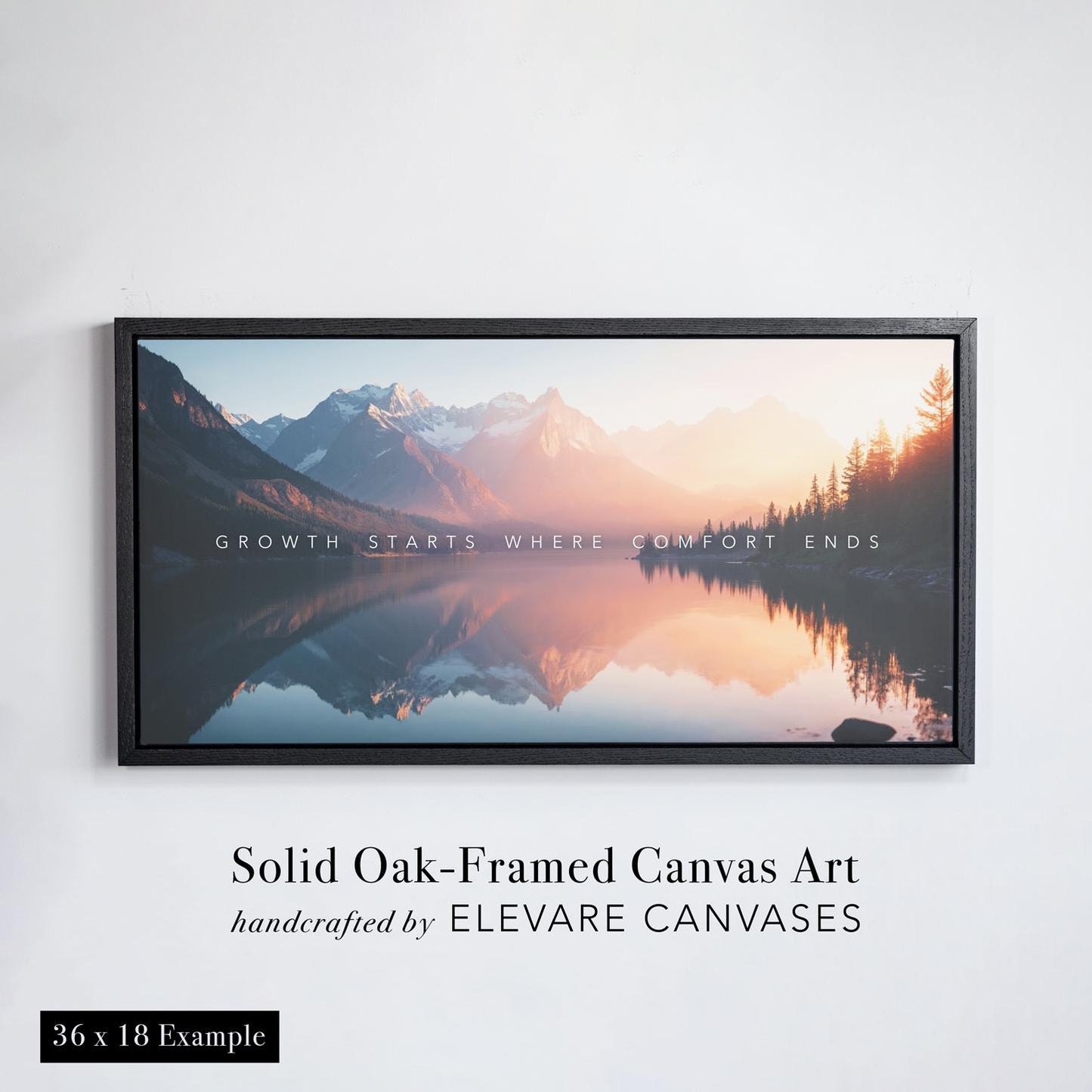Framed canvas wall art featuring a serene mountain landscape with a glassy lake reflecting snow-capped peaks and a glowing sunset. The artwork is presented in a solid oak floater frame with a bold profile, handcrafted by Elevare Canvases. The canvas displays the inspirational quote “Growth starts where comfort ends” across the center. This is a 36 x 24 inch example shown against a white wall.