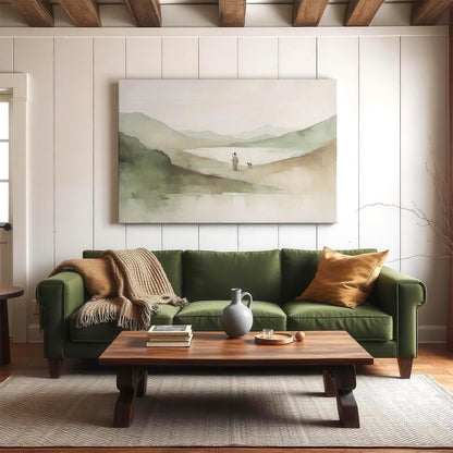 Large Christian landscape canvas displayed in a cozy modern living room above a green sofa. The art features Jesus walking with a lamb in a misty, neutral-toned valley—ideal for creating a calming, faith-filled atmosphere. Great for shoppers seeking oversized religious wall art, Christian living room decor, or peaceful Jesus artwork in a natural modern style.